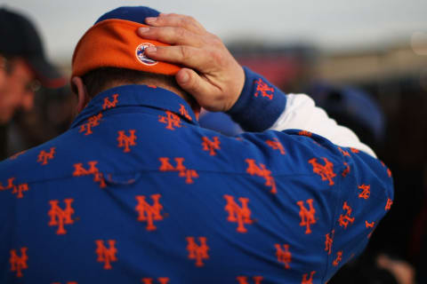 NEW YORK – APRIL 13: A fan adjusts his hat before the start of the Opening Day game between the San Diego Padres and the New York Mets at Citi Field on April 13, 2009 in the Flushing neighborhood of the Queens borough of New York City. This is the first regular season MLB game being played at the new venue which replaced Shea stadium as the Mets home field. (Photo by Spencer Platt/Getty Images)