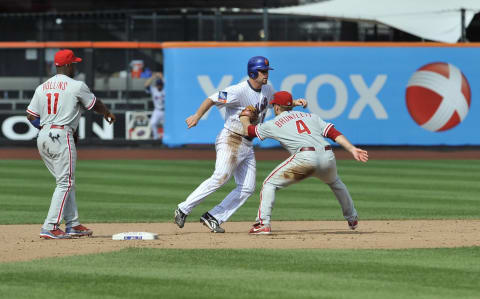 NEW YORK – AUGUST 23: Second baseman Eric Bruntlett #4 of the Philadelphia Phillies ends the game with an unassisted triple play as he tags out Daniel Murphy #28 of the New York Mets for the third out. Bruntlett turned the 15th unassisted triple play in MLB history, and only the second that ended a game. With runners on first and second in the ninth inning, Jeff Francoeur hit a line drive up the middle that Bruntlett caught for the first out, then stepped on second to double up Luis Castillo and finally tagged Murphy for the third out. The Phillies won 9-7. (Photo by Jason Szenes/Getty Images)