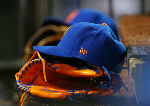 NEW YORK, NY – APRIL 03: A cap and glove of a New York Mets player sits on the step of the dugout during a game against the Philadelphia Phillies at Citi Field on April 3, 2018 in the Flushing neighborhood of the Queens borough of New York City. (Photo by Rich Schultz/Getty Images)