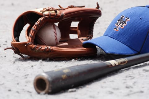 MIAMI, FL – MAY 16: Detail view of a New York Mets glove, hat, bat and baseball on the field during a MLB game against the Florida Marlins in Sun Life Stadium on May 16, 2010 in Miami, Florida. (Photo by Ronald C. Modra/Getty Images)