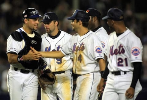 New York Mets catcher Mike Piazza (L) is congratulated by teammates (2nd, L to R) Todd Ziele, Robin Ventura, Armando Benitez and Bobby Jones after the Mets beat the Atlanta Braves 3-2 behind an eighth inning 2-run home run by Piazza 21 September, 2001 at Shea Stadium in New York City. Security was high and the signs of patriotism everywhere as the two teams played the first baseball game in New York since the terrorist attack on the World Trade Center twin towers 11 September. AFP PHOTO/Matt CAMPBELL (Photo by MATT CAMPBELL / AFP) (Photo credit should read MATT CAMPBELL/AFP via Getty Images)