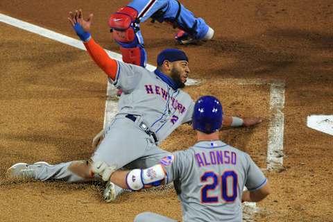 PHILADELPHIA, PA – SEPTEMBER 17: Dominic Smith #2 of the New York Mets slides safely into home plate in the first inning against the Philadelphia Phillies as teammate Pete Alonso #20 looks on at Citizens Bank Park on September 17, 2020 in Philadelphia, Pennsylvania. (Photo by Drew Hallowell/Getty Images)