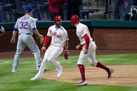 PHILADELPHIA, PA – APRIL 05: Bryce Harper #3 and Rhys Hoskins #17 of the Philadelphia Phillies celebrate in front of Aaron Loup #32 of the New York Mets after both Harper and Hoskins scored a run in the bottom of the eighth inning at Citizens Bank Park on April 5, 2021 in Philadelphia, Pennsylvania. The Phillies defeated the Mets 5-3. (Photo by Mitchell Leff/Getty Images)