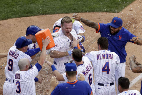 NEW YORK, NY – AUGUST 12: Pete Alonso #20 of the New York Mets is congratulated by teammates after hitting a walk-off home run to defeat the Washington Nationals in game two of a doubleheader at Citi Field on August 12, 2021 in New York City. The Mets won 5-4. (Photo by Adam Hunger/Getty Images)