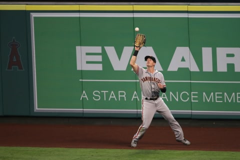 ANAHEIM, CALIFORNIA – AUGUST 17: Mike Yastrzemski #5 of the San Francisco Giants makes the play on a sacrifice fly RBI hit by Tommy La Stella #9 of the Los Angeles Angels during the third inning of a game at Angel Stadium of Anaheim on August 17, 2020 in Anaheim, California. (Photo by Sean M. Haffey/Getty Images)