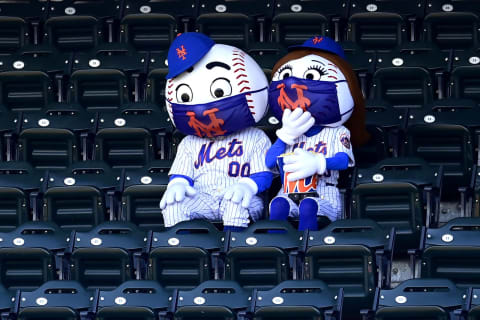 NEW YORK, NEW YORK – SEPTEMBER 06: Mr. and Mrs. Met share popcorn as they sit in the empty seats during the game between the Philadelphia Phillies and New York Mets at Citi Field on September 06, 2020 in New York City. Due to concerns of the spread of the coronavirus, MLB games are being played without fans. (Photo by Steven Ryan/Getty Images)