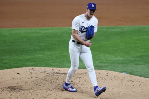 ARLINGTON, TEXAS – OCTOBER 06: Walker Buehler #21 of the Los Angeles Dodgers reacts after striking out Trent Grisham #2 of the San Diego Padres during Game One of the National League Divisional Series at Globe Life Field on October 06, 2020 in Arlington, Texas. (Photo by Tom Pennington/Getty Images)