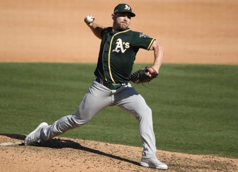 LOS ANGELES, CALIFORNIA – OCTOBER 07: Liam Hendriks #16 of the Oakland Athletics pitches against the Houston Astros during the seventh inning in Game Three of the American League Division Series at Dodger Stadium on October 07, 2020 in Los Angeles, California. (Photo by Kevork Djansezian/Getty Images)