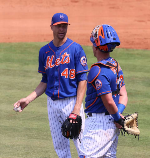 PORT ST. LUCIE, FLORIDA – MARCH 16: Jacob deGrom #48 speaks with James McCann #33 of the New York Mets in between action against the Houston Astros in a spring training game at Clover Park on March 16, 2021 in Port St. Lucie, Florida. (Photo by Mark Brown/Getty Images)