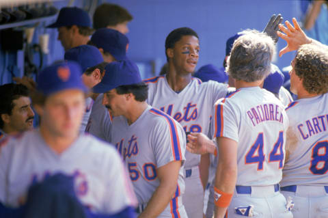 UNDATED: Darryl Strawberry #18 of the New York Mets gets high-fives by his teammates in the dugout during a game circa 1983-1990. (Photo by Andrew D. Bernstein/Getty Images)