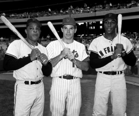 FLUSHING, NY – 1965: Outfielder Willie Mays #24 (left) and firstbaseman Willie McCovey #44 (right) of the San Francisco Giants flank rookie outfielder Ron Swoboda #14 of the New York Mets as they pose for a portrait prior to a game in 1965 at Shea Stadium in Flushing, New York. (Photo by: Kidwiler Collection/Diamond Images/Getty Images)