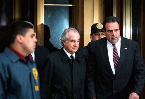 NEW YORK – MARCH 10: Financier Bernard Madoff (C) leaves Manhattan Federal court March 10, 2009 in New York City. Madoff attended a hearing regarding the conflicting status of his legal representation in his multi-billion dollar fraud allegations. His lawyer, Ira Sorkin, has told a judge his client is expected to plead guilty to 11 counts including money laundering, perjury and securities, mail and wire fraud. (Photo by Chris Hondros/Getty Images)