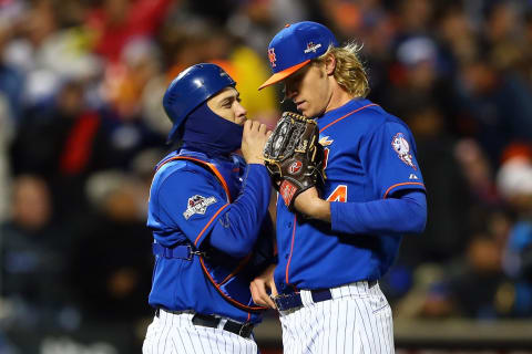 NEW YORK, NY – OCTOBER 18: Noah Syndergaard #34 of the New York Mets talks with Travis d’Arnaud #7 against the Chicago Cubs during game two of the 2015 MLB National League Championship Series at Citi Field on October 18, 2015 in the Flushing neighborhood of the Queens borough of New York City. (Photo by Elsa/Getty Images)