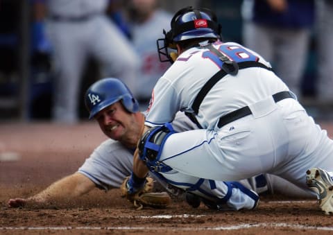 NEW YORK – OCTOBER 04: Jeff Kent #12 of the Los Angeles Dodgers is tagged out at the plate for the first out in an unasisted double play by Paul Lo Duca #16 of the New York Mets in the second inning of game one of the National League Division Series at Shea Stadium on October 4, 2006 in the Flushing neighborhood of Queens borough of New York City. J.D Drew #7 was also tagged out at home on the play. (Photo by Chris McGrath/Getty Images)