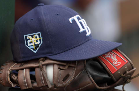 May 20, 2018; Anaheim, CA, USA; Detailed view of Tampa Bay Rays cap with 20th anniversary log and Rawlings glove in the dugout during the game against the Los Angeles Angels at Angel Stadium of Anaheim. Mandatory Credit: Kirby Lee-USA TODAY Sports