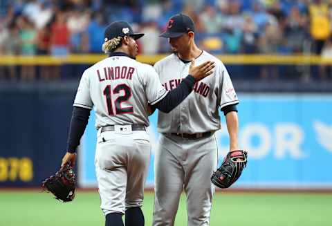 Sep 1, 2019; St. Petersburg, FL, USA; Cleveland Indians pitcher Carlos Carrasco (59) gets a hug from shortstop Francisco Lindor (12) as he comes in to pitch the seventh inning against the Tampa Bay Rays at Tropicana Field. Mandatory Credit: Kim Klement-USA TODAY Sports