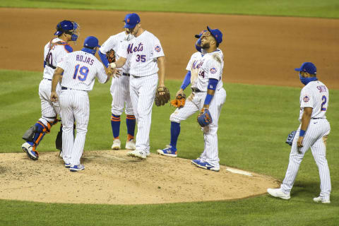 Sep 4, 2020; New York City, New York, USA; New York Mets manager Luis Rojas (19) takes out pitcher Jared Hughes (35) in the eighth inning against the Philadelphia Phillies at Citi Field. Mandatory Credit: Wendell Cruz-USA TODAY Sports