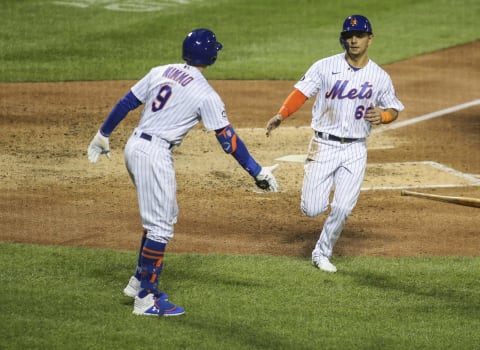 Sep 19, 2020; New York City, New York, USA; New York Mets shortstop Andres Gimenez (60) is greeted by center fielder Brandon Nimmo (9) after scoring in the fourth inning against the Atlanta Braves at Citi Field. Mandatory Credit: Wendell Cruz-USA TODAY Sports