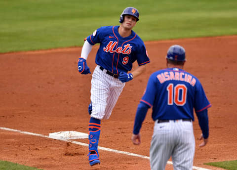 Mar 4, 2021; Port St. Lucie, Florida, USA; New York Mets center fielder Brandon Nimmo (9) rounds third base after hitting a solo home run against the Washington Nationals and is greeted by third base coach Gary Disarcina during a spring training game at Clover Park. Mandatory Credit: Jim Rassol-USA TODAY Sports