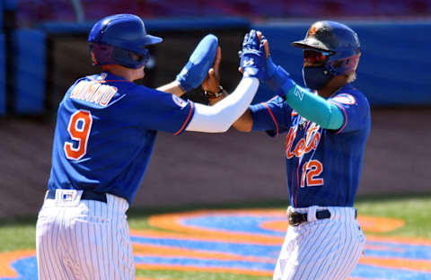 Mar 14, 2021; Port St. Lucie, Florida, USA; New York Mets shortstop Francisco Lindor (12) is congratulated by teammate Brandon Nimmo (9) after both scored in the fifth inning against the St. Louis Cardinals during a spring training game at Clover Park. Mandatory Credit: Jim Rassol-USA TODAY Sports