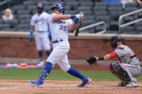 Apr 25, 2021; New York City, New York, USA; New York Mets catcher James McCann (33) hits an RBI single during the bottom of the fourth inning against the Washington Nationals at Citi Field. Mandatory Credit: Vincent Carchietta-USA TODAY Sports