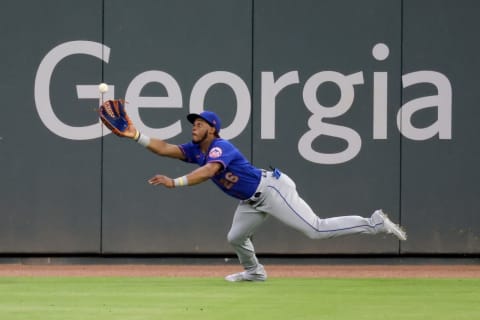 May 18, 2021; Atlanta, Georgia, USA; New York Mets outfielder Khalil Lee (26) makes a leaping catch to get out Atlanta Braves second baseman Ozzie Albies (not pictured) during the sixth inning at Truist Park. Mandatory Credit: Jason Getz-USA TODAY Sports