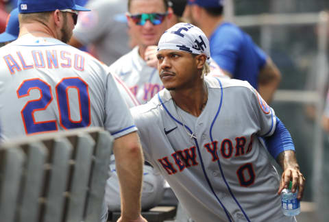 Jul 21, 2021; Cincinnati, Ohio, USA; New York Mets starting pitcher Marcus Stroman (0) talks with first baseman Pete Alonso (20) in the dugout during the ninth inning against the Cincinnati Reds at Great American Ball Park. Mandatory Credit: David Kohl-USA TODAY Sports