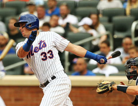 Jul 29, 2021; New York City, New York, USA; New York Mets catcher James McCann (33) singles against the Atlanta Braves during the eighth inning at Citi Field. Mandatory Credit: Andy Marlin-USA TODAY Sports