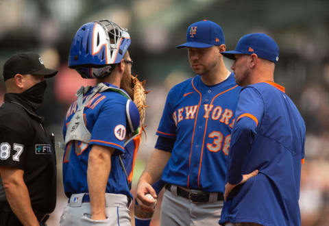 Aug 18, 2021; San Francisco, California, USA; New York Mets pitcher Tylor Megill (38) confers with catcher Patrick Mazeika (76) and pitching coach Jeremy Hefner during the third inning while home plate umpire Scott Barry (87) tries to hurry things along at Oracle Park. Mandatory Credit: D. Ross Cameron-USA TODAY Sports