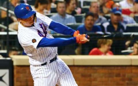 Aug 6, 2018; New York City, NY, USA; New York Mets first baseman Wilmer Flores (4) singles against the Cincinnati Reds during the third inning at Citi Field. Mandatory Credit: Andy Marlin-USA TODAY Sports