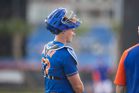 Feb 22, 2021; Port St. Lucie, Florida, USA; New York Mets catcher James McCann (33) watches field drills during the first day of full-squad spring training workouts at Clover Park. Mandatory Credit: Mary Holt-USA TODAY Sports