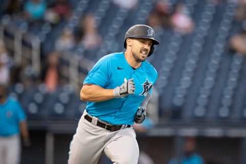 Mar 16, 2021; West Palm Beach, Florida, USA; Miami Marlins left fielder Adam Duvall (14) runs to first base during a spring training game between the Miami Marlins and the Washington Nationals at FITTEAM Ballpark of the Palm Beaches. Mandatory Credit: Mary Holt-USA TODAY Sports