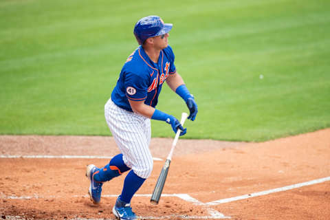 Mar 18, 2021; Port St. Lucie, Florida, USA; New York Mets catcher James McCann (33) hits a one-run double during a spring training game between the Washington Nationals and the New York Mets at Clover Park. Mandatory Credit: Mary Holt-USA TODAY Sports