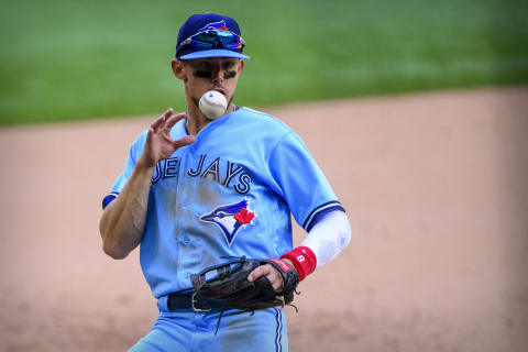 Apr 7, 2021; Arlington, Texas, USA; Toronto Blue Jays third baseman Cavan Biggio (8) bare hands a ball hit by Texas Rangers designated hitter Joey Gallo (not pictured) during the eighth inning at Globe Life Field. Mandatory Credit: Jerome Miron-USA TODAY Sports