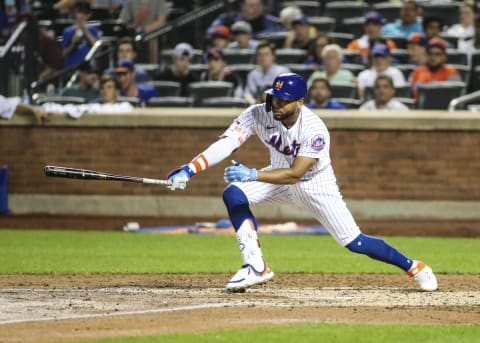 Jun 25, 2021; New York City, New York, USA; New York Mets left fielder Dominic Smith (2) hits a single in the fourth inning against the Philadelphia Phillies at Citi Field. Mandatory Credit: Wendell Cruz-USA TODAY Sports