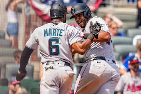 Jul 4, 2021; Cumberland, Georgia, USA; Miami Marlins first baseman Jesus Aguilar (24) reacts with center fielder Starling Marte (6) after hitting a two run home run against the Atlanta Braves during the ninth inning at Truist Park. Mandatory Credit: Dale Zanine-USA TODAY Sports