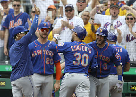 Jul 18, 2021; Pittsburgh, Pennsylvania, USA; New York Mets pitcher Marcus Stroman (left) and first baseman Pete Alonso (20) and catcher Tomas Nido (3) congratulate right fielder Michael Conforto (30) after Conforto hit a two run game winning home run against the Pittsburgh Pirates during the ninth inning at PNC Park. The Mets won 7-6. Mandatory Credit: Charles LeClaire-USA TODAY Sports