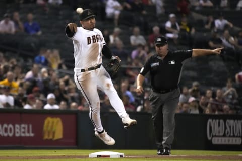 Jul 19, 2021; Phoenix, Arizona, USA; Arizona Diamondbacks third baseman Eduardo Escobar (5) makes the off balance play against the Pittsburgh Pirates in the fifth inning at Chase Field. Mandatory Credit: Rick Scuteri-USA TODAY Sports