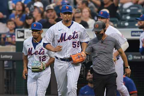 Aug 26, 2021; New York City, New York, USA; New York Mets starting pitcher Carlos Carrasco (59) and shortstop Francisco Lindor (12) walk on to the field before his game against the San Francisco Giants at Citi Field. Mandatory Credit: Vincent Carchietta-USA TODAY Sports