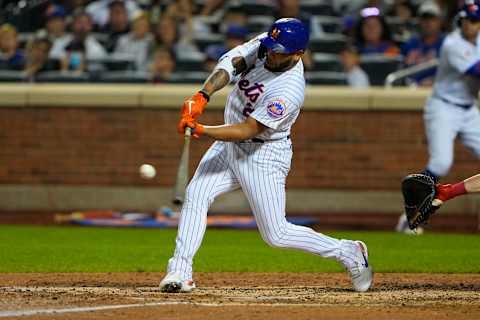 Sep 19, 2021; New York City, New York, USA; New York Mets left fielder Dominic Smith (2) hits an RBI double during the fifth inning against the Philadelphia Phillies at Citi Field. Mandatory Credit: Gregory Fisher-USA TODAY Sports