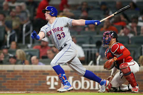 Oct 1, 2021; Atlanta, Georgia, USA; New York Mets catcher James McCann (33) hits a RBI single against the Atlanta Braves in the fourth inning at Truist Park. Mandatory Credit: Brett Davis-USA TODAY Sports