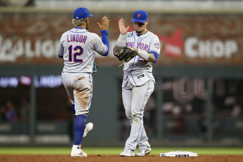 Oct 1, 2021; Atlanta, Georgia, USA; New York Mets shortstop Francisco Lindor (12) and second baseman Javier Baez (23) celebrate after a victory against the Atlanta Braves at Truist Park. Mandatory Credit: Brett Davis-USA TODAY Sports