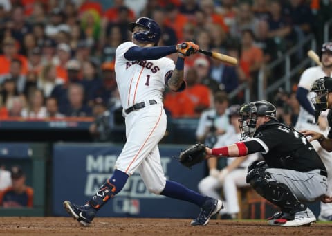 Oct 7, 2021; Houston, Texas, USA; Houston Astros shortstop Carlos Correa (1) hits a single against the Chicago White Sox during the seventh inning in game one of the 2021 ALDS at Minute Maid Park. Mandatory Credit: Thomas Shea-USA TODAY Sports