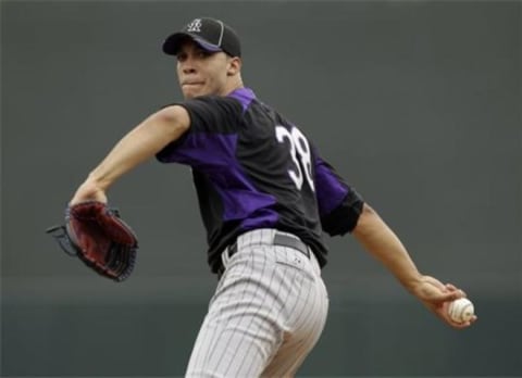 Ubaldo Jimenez warms up before a game for the Colorado Rockies.