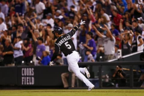 Jul 24, 2015; Denver, CO, USA; Colorado Rockies right fielder Carlos Gonzalez (5) reacts after hitting a home run in the eighth inning against the Cincinnati Reds at Coors Field. Mandatory Credit: Isaiah J. Downing-USA TODAY Sports