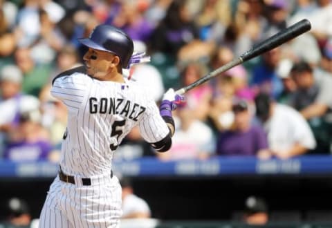 Aug 23, 2015; Denver, CO, USA; Colorado Rockies right fielder Carlos Gonzalez (5) hits a home run during the fourth inning against the New York Mets at Coors Field. The Mets won 5-1. Mandatory Credit: Chris Humphreys-USA TODAY Sports