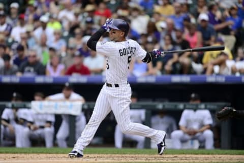 Aug 16, 2015; Denver, CO, USA; Colorado Rockies right fielder Carlos Gonzalez (5) hits a solo home run in the fourth inning against the San Diego Padres at Coors Field. The Rockies defeated the Padres 5-0. Mandatory Credit: Ron Chenoy-USA TODAY Sports