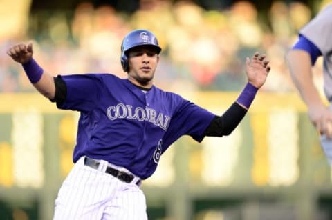 Sep 25, 2015; Denver, CO, USA; Colorado Rockies shortstop Cristhian Adames (18) slides into third base in the first inning against the Los Angeles Dodgers at Coors Field. Mandatory Credit: Ron Chenoy-USA TODAY Sports