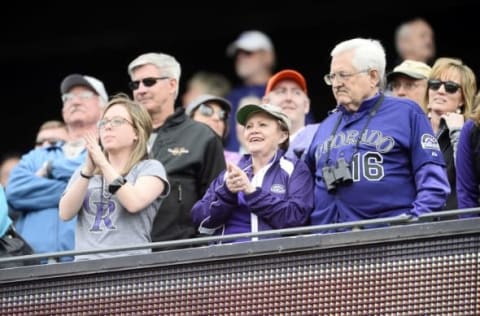 Apr 8, 2016; Denver, CO, USA; Colorado Rockies fans cheer during the seventh inning stretch during the game against the San Diego Padres at Coors Field. The Padres defeated the Rockies 13-6. Mandatory Credit: Ron Chenoy-USA TODAY Sports