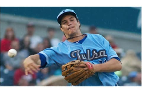 Nolan Arenado makes a throw for the Tulsa Drillers in 2012. Photo by Rich Crimi.